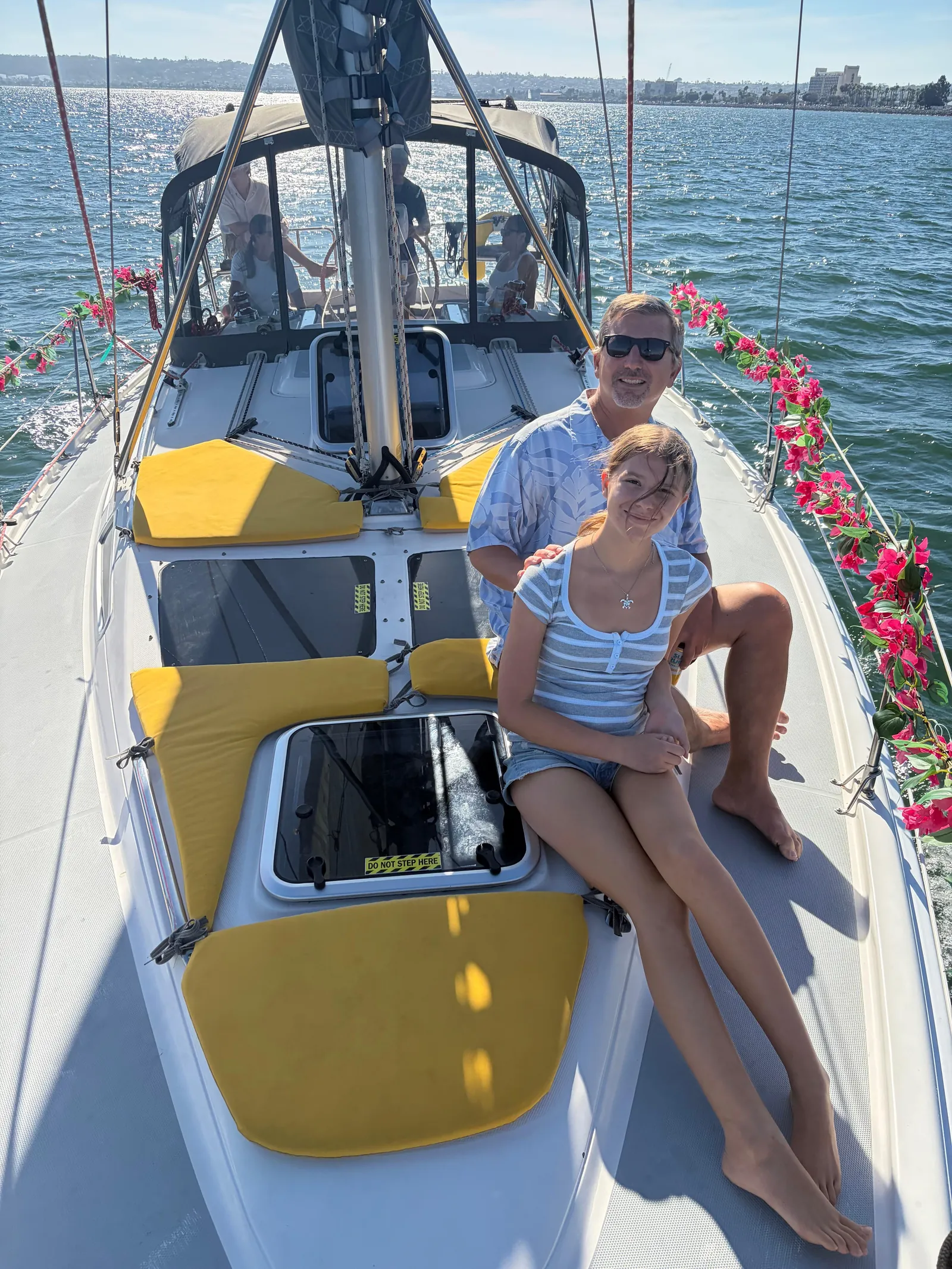 Guests relaxing on the cushioned deck of a sailboat